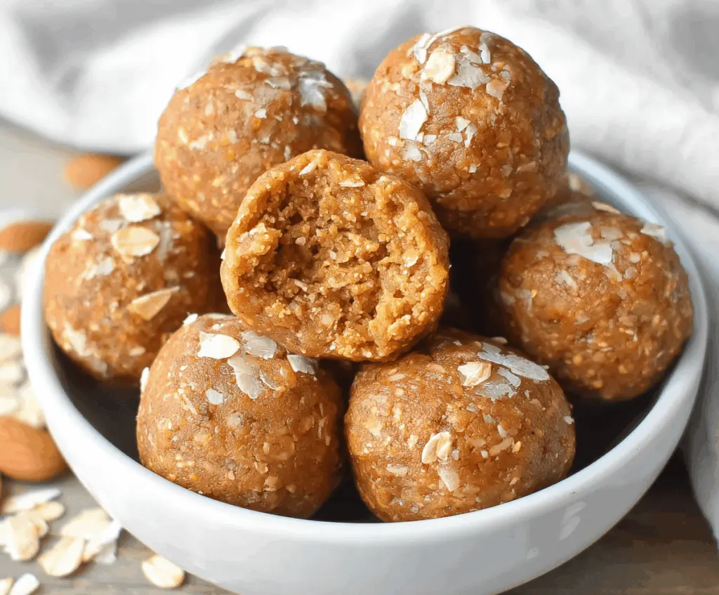 Healthy almond butter pumpkin protein balls on a white plate, perfect for a nutritious snack or energy boost.