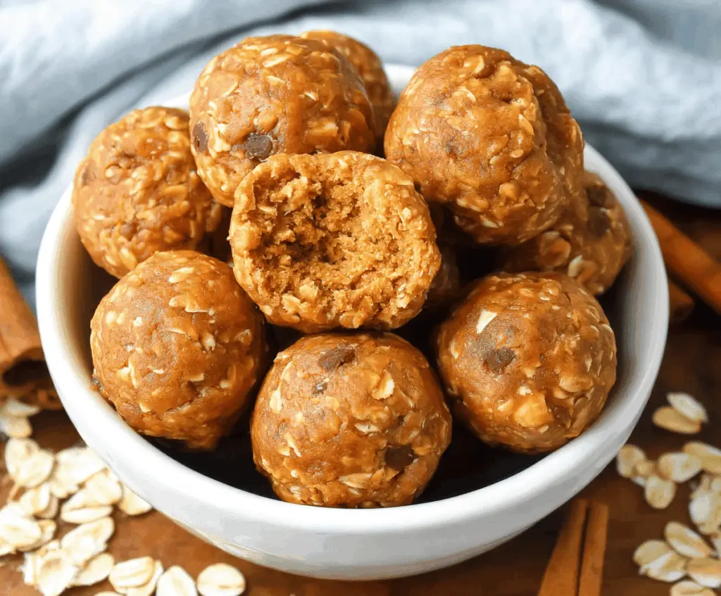 Healthy oatmeal pumpkin protein balls on a white plate, featuring oats, pumpkin puree, and protein powder, perfect for a nutritious snack.