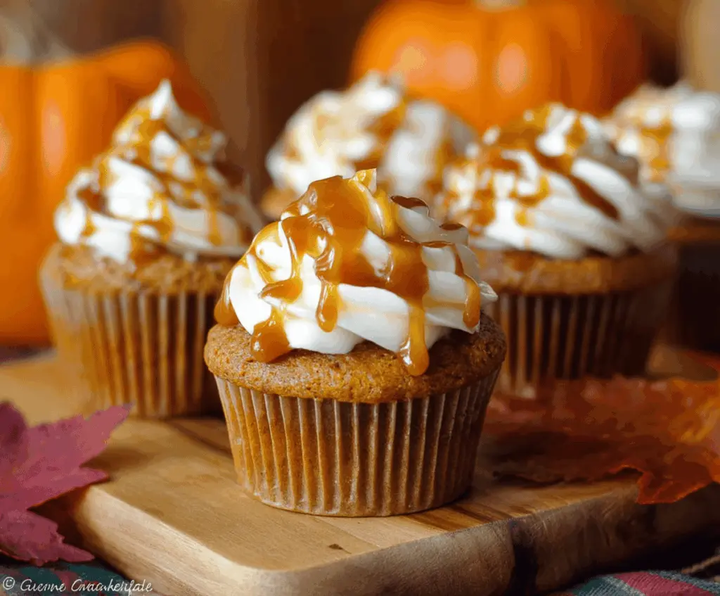 Delicious Pumpkin Caramel Cupcakes topped with whipped cream and caramel drizzle, perfect for fall desserts.