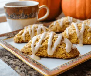 Delicious pumpkin scones topped with creamy maple icing, perfect for breakfast or teatime.